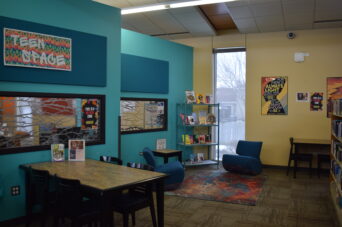 Photo of table, chairs, and lounge area for the Teen Space