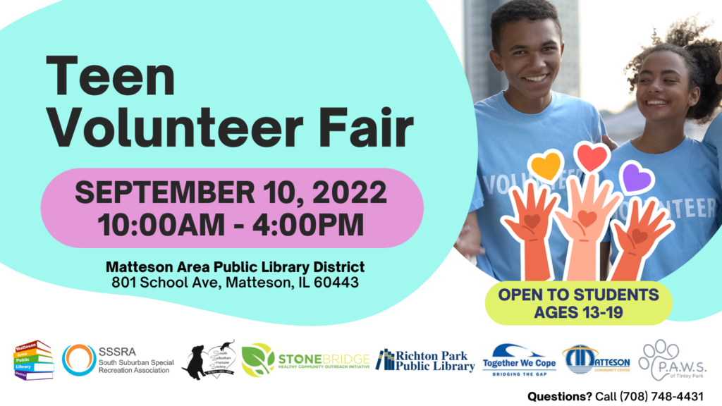 Picture of two teens in volunteer shirts with Volunteer Fair information
